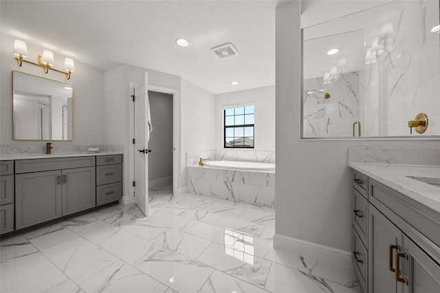 8932 Isabella Cir, Parrish, FL 34219 - full bathroom with baseboards, two vanities, a garden tub, marble look tiles, and recessed lighting