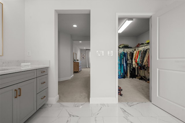 8932 Isabella Cir, Parrish, FL 34219 - bathroom with vanity, baseboards, marble finish flooring, a spacious closet, and recessed lighting