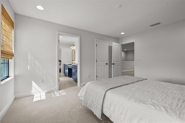 8932 Isabella Cir, Parrish, FL 34219 - bedroom with baseboards, light colored carpet, recessed lighting, and ensuite bath