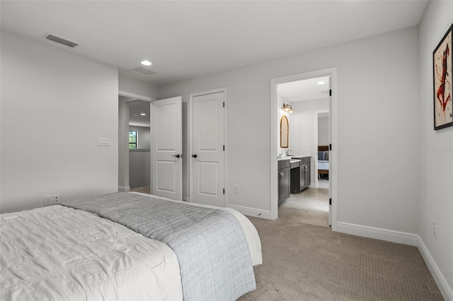 8932 Isabella Cir, Parrish, FL 34219 - bedroom featuring light carpet, recessed lighting, baseboards, and connected bathroom