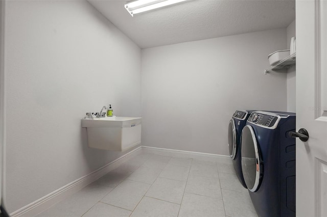 8932 Isabella Cir, Parrish, FL 34219 - washroom featuring washer and clothes dryer, light tile patterned floors, a textured ceiling, and baseboards