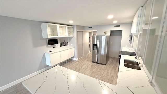 6400 46th Ave N Unit 113, Kenneth City, FL 33709 - kitchen with stainless steel appliances, light wood-style flooring, white cabinetry, light stone counters, and recessed lighting