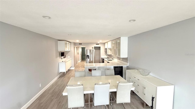 6400 46th Ave N Unit 113, Kenneth City, FL 33709 - dining area with wood finished floors, beverage cooler, recessed lighting, and baseboards