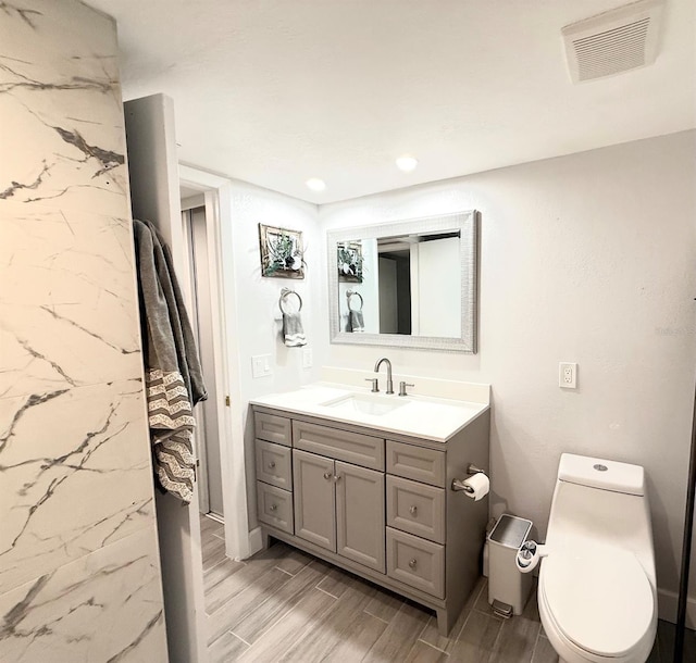 6400 46th Ave N Unit 113, Kenneth City, FL 33709 - bathroom with vanity, wood tiled floors, toilet, and recessed lighting