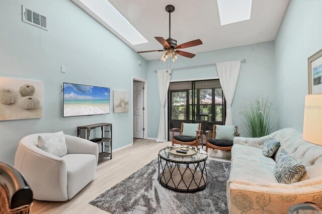 2906 63rd St W Unit 206, Bradenton, FL 34209 - living room featuring a skylight, wood finished floors, a ceiling fan, and baseboards
