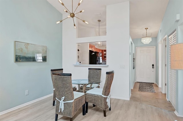 2906 63rd St W Unit 206, Bradenton, FL 34209 - dining area featuring a chandelier, wood finished floors, and baseboards