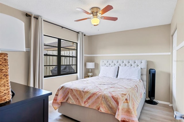 2906 63rd St W Unit 206, Bradenton, FL 34209 - bedroom featuring wood finished floors, a ceiling fan, and baseboards