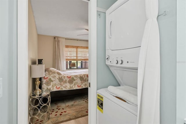 2906 63rd St W Unit 206, Bradenton, FL 34209 - washroom featuring stacked washer / drying machine, wood finished floors, and ceiling fan