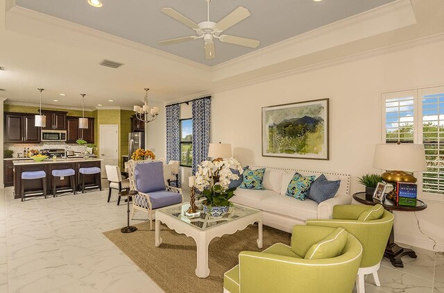 26687 Raphis Royale Blvd, Englewood, FL 34223 - living area with ornamental molding, light marble finish flooring, recessed lighting, a raised ceiling, and a chandelier
