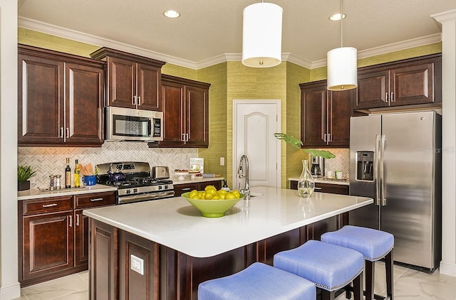 26687 Raphis Royale Blvd, Englewood, FL 34223 - kitchen featuring appliances with stainless steel finishes, light marble finish floors, a kitchen bar, light countertops, and ornamental molding