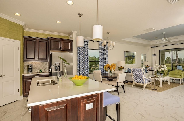 26687 Raphis Royale Blvd, Englewood, FL 34223 - kitchen featuring stainless steel fridge, a sink, light countertops, light marble finish floors, and recessed lighting