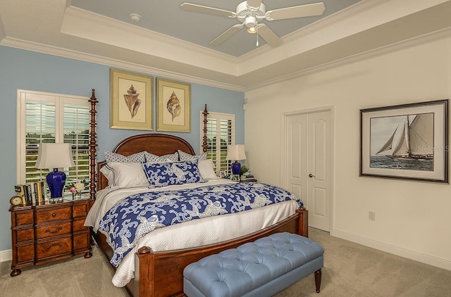 26687 Raphis Royale Blvd, Englewood, FL 34223 - bedroom with carpet floors, multiple windows, a tray ceiling, and crown molding