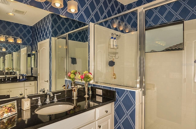 26687 Raphis Royale Blvd, Englewood, FL 34223 - full bathroom with wallpapered walls, a shower stall, and vanity