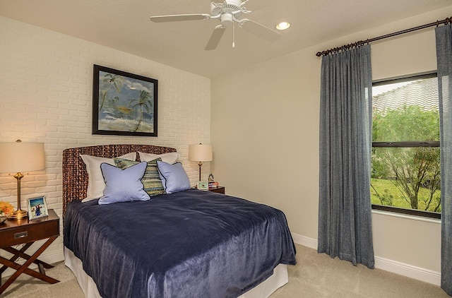 26687 Raphis Royale Blvd, Englewood, FL 34223 - bedroom with light colored carpet, baseboards, brick wall, and a ceiling fan