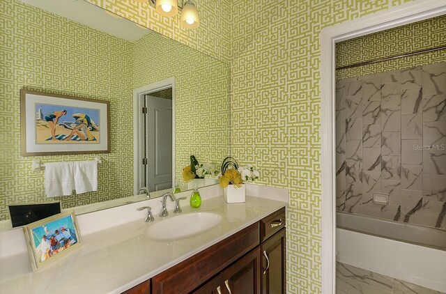26687 Raphis Royale Blvd, Englewood, FL 34223 - bathroom featuring vanity, marble finish flooring, and shower / bathtub combination