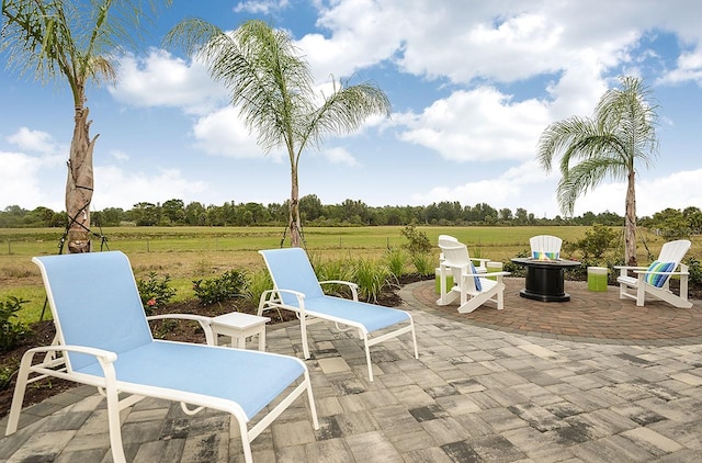 26687 Raphis Royale Blvd, Englewood, FL 34223 - view of patio featuring a rural view and an outdoor fire pit
