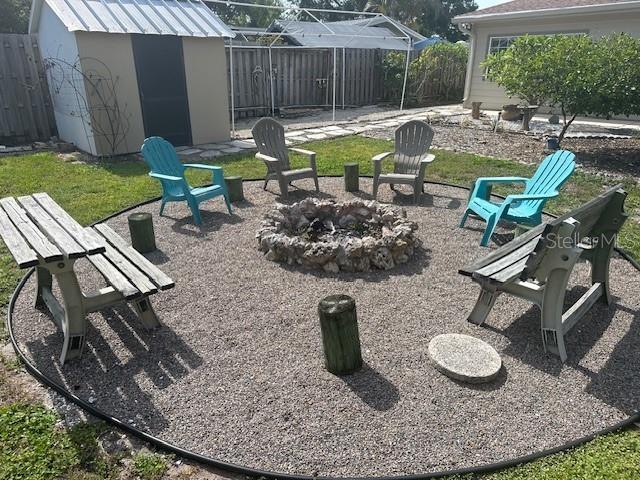 3060 Courtland St, Sarasota, FL 34237 - fenced backyard featuring a fire pit