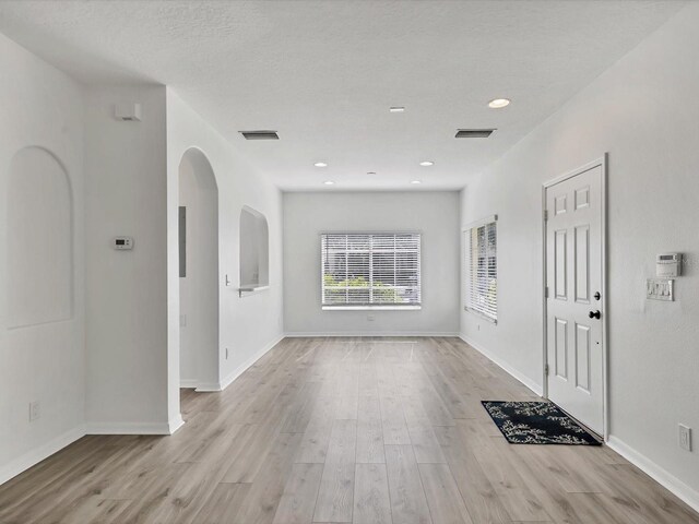 262 Cape Harbour Loop Unit 101, Bradenton, FL 34212 - entrance foyer with wood finished floors, arched walkways, baseboards, and recessed lighting