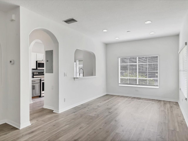 262 Cape Harbour Loop Unit 101, Bradenton, FL 34212 - spare room with light wood finished floors, baseboards, electric panel, and recessed lighting