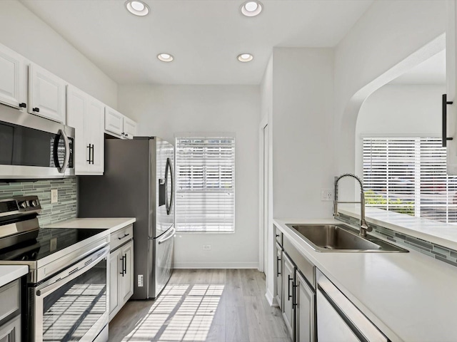 262 Cape Harbour Loop Unit 101, Bradenton, FL 34212 - kitchen with appliances with stainless steel finishes, a sink, tasteful backsplash, light countertops, and recessed lighting