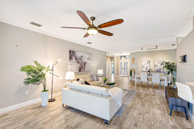 8640 Stone Harbour Loop, Bradenton, FL 34212 - living room with light wood-style flooring, ceiling fan, crown molding, baseboards, and a desk