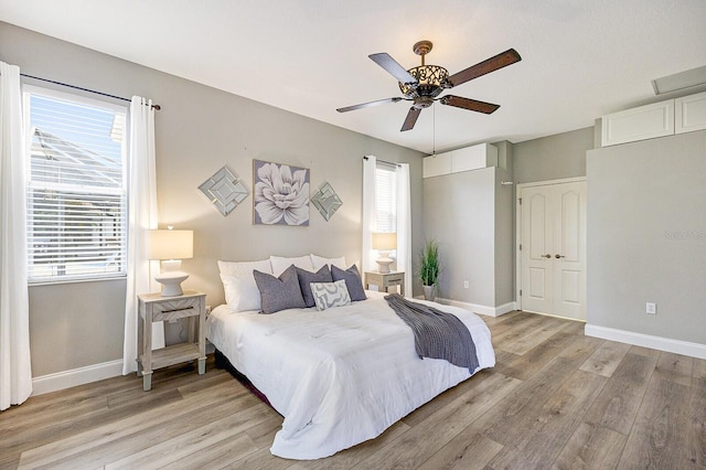 8640 Stone Harbour Loop, Bradenton, FL 34212 - bedroom featuring multiple windows and light wood-type flooring