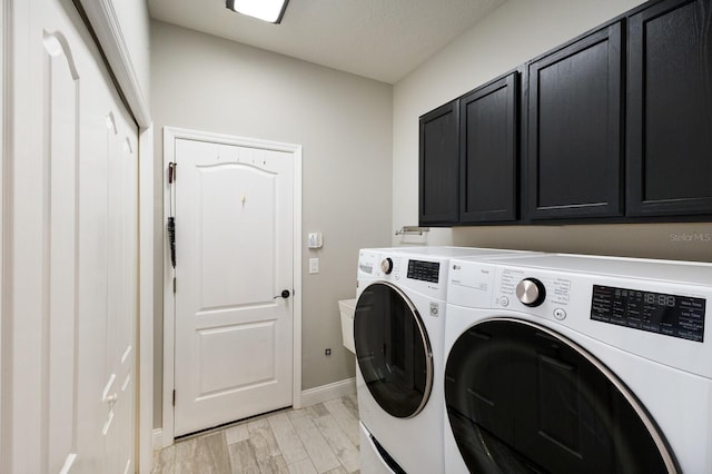8640 Stone Harbour Loop, Bradenton, FL 34212 - laundry area featuring washer and clothes dryer, cabinet space, baseboards, and light wood-style floors
