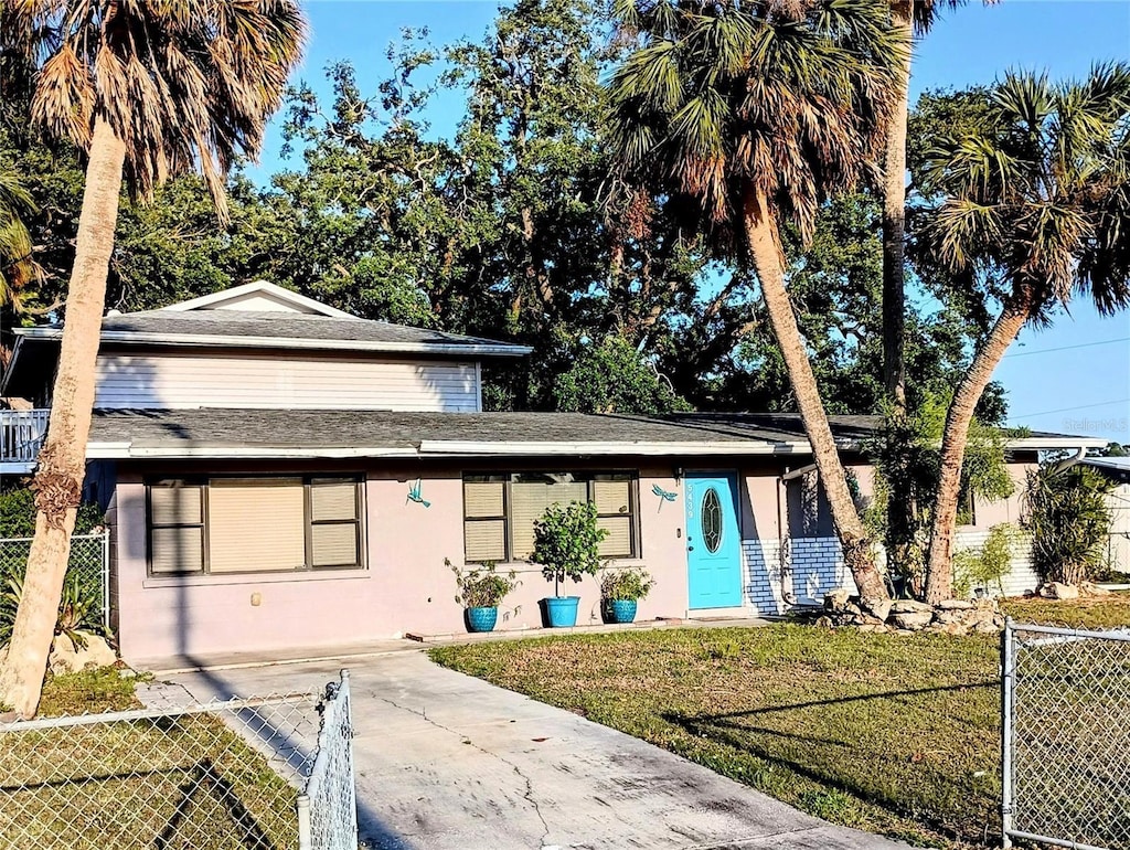 5439 3rd St E, Bradenton, FL 34203 - view of front of home with stucco siding, a shingled roof, and concrete driveway