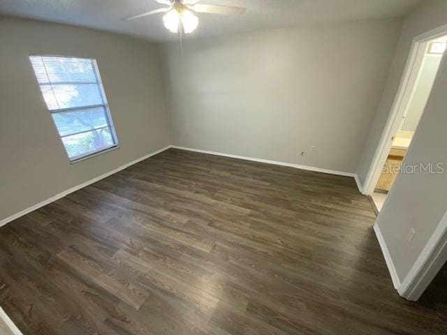 6923 13th Ave E, Bradenton, FL 34208 - spare room featuring healthy amount of natural light, ceiling fan, dark wood finished floors, and baseboards