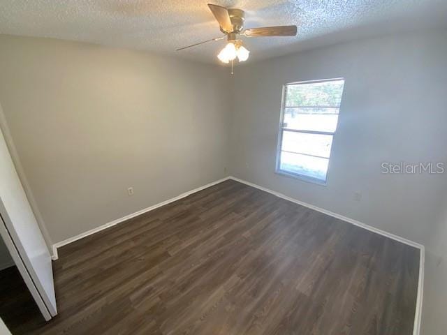 6923 13th Ave E, Bradenton, FL 34208 - empty room featuring dark wood-type flooring, a textured ceiling, baseboards, and ceiling fan