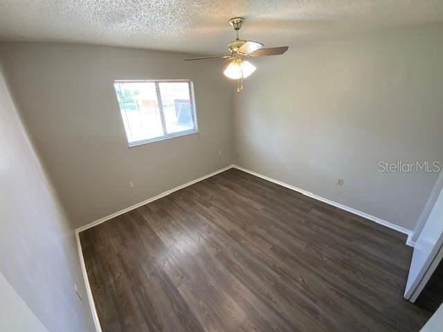 6923 13th Ave E, Bradenton, FL 34208 - unfurnished room featuring ceiling fan, a textured ceiling, dark wood-type flooring, and baseboards