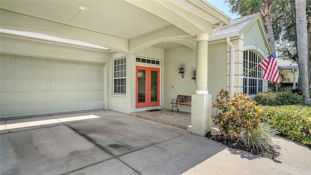 4612 4th Ave E, Bradenton, FL 34208 - doorway to property with stucco siding, french doors, a garage, and concrete driveway