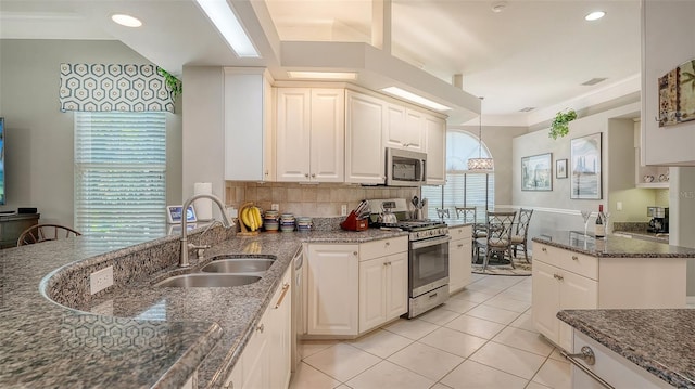 4612 4th Ave E, Bradenton, FL 34208 - kitchen featuring stainless steel appliances, a sink, dark stone countertops, tasteful backsplash, and light tile patterned floors