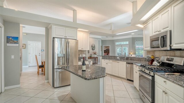 4612 4th Ave E, Bradenton, FL 34208 - kitchen featuring stainless steel appliances, light tile patterned flooring, dark stone countertops, and recessed lighting