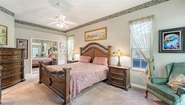4612 4th Ave E, Bradenton, FL 34208 - bedroom with light carpet, baseboards, ceiling fan, and a closet