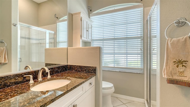 4612 4th Ave E, Bradenton, FL 34208 - bathroom with vanity, toilet, a stall shower, tile patterned floors, and baseboards