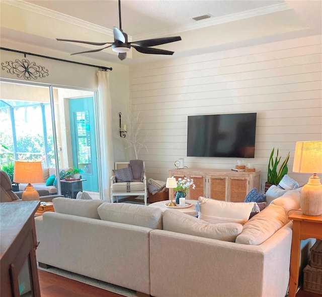 2149 Muskogee Trl, Nokomis, FL 34275 - living area with crown molding, a ceiling fan, dark wood-style flooring, and wood walls