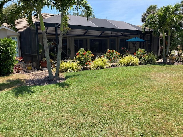2149 Muskogee Trl, Nokomis, FL 34275 - rear view of property featuring a lawn and glass enclosure