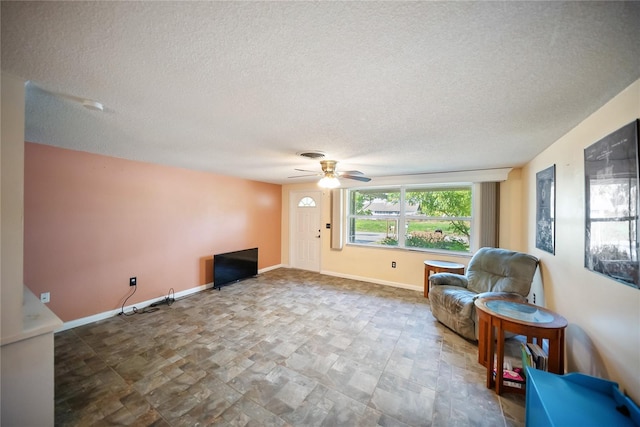 3468 Roslyn Rd, Venice, FL 34293 - living area with a textured ceiling, a ceiling fan, and baseboards