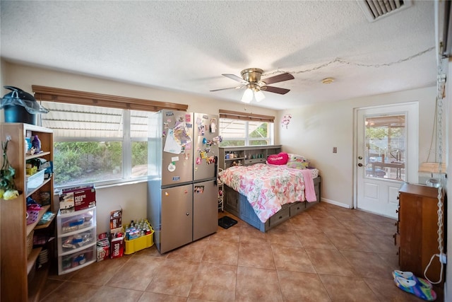 3468 Roslyn Rd, Venice, FL 34293 - tiled bedroom with freestanding refrigerator, a textured ceiling, and a ceiling fan