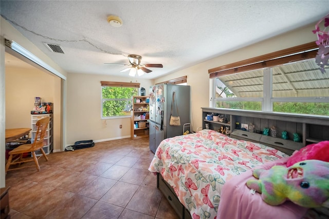 3468 Roslyn Rd, Venice, FL 34293 - bedroom featuring freestanding refrigerator, tile patterned flooring, a closet, baseboards, and a ceiling fan