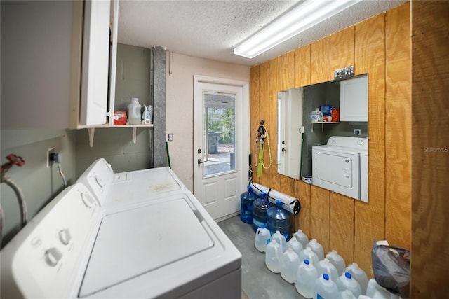 3468 Roslyn Rd, Venice, FL 34293 - laundry area featuring washer and clothes dryer, cabinet space, and a textured ceiling