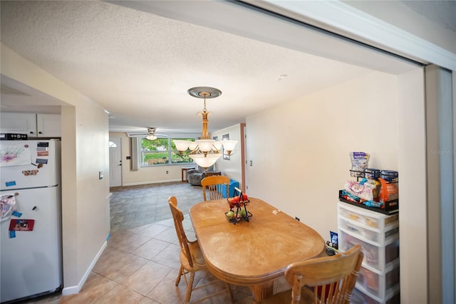 3468 Roslyn Rd, Venice, FL 34293 - dining room with light tile patterned flooring, baseboards, and a textured ceiling