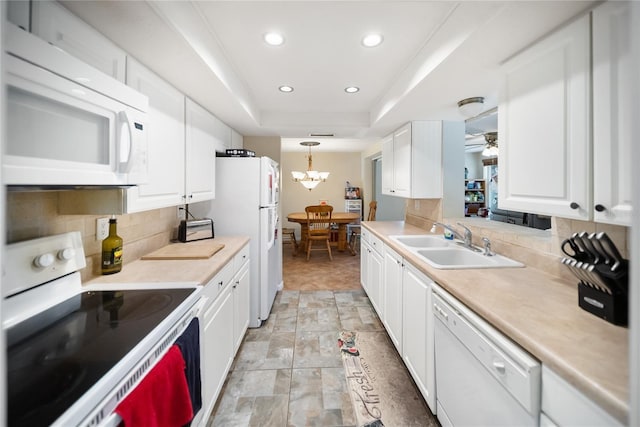 3468 Roslyn Rd, Venice, FL 34293 - kitchen with white appliances, a sink, tasteful backsplash, white cabinetry, and recessed lighting