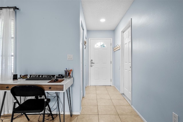 4076 Vana Dr, Sarasota, FL 34241 - doorway to outside with light tile patterned floors, baseboards, and a textured ceiling