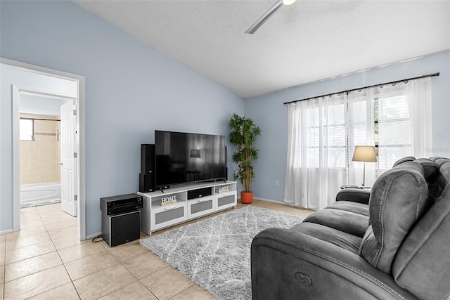 4076 Vana Dr, Sarasota, FL 34241 - tiled living area with lofted ceiling, healthy amount of natural light, a textured ceiling, baseboards, and ceiling fan
