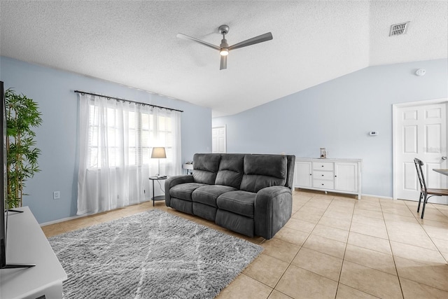 4076 Vana Dr, Sarasota, FL 34241 - living area featuring ceiling fan, lofted ceiling, light tile patterned flooring, and a textured ceiling
