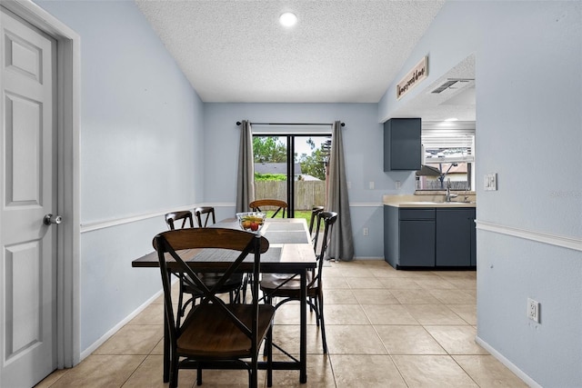 4076 Vana Dr, Sarasota, FL 34241 - dining area with a textured ceiling, light tile patterned floors, and baseboards