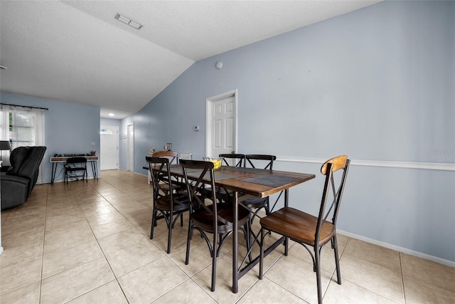 4076 Vana Dr, Sarasota, FL 34241 - dining room featuring vaulted ceiling, light tile patterned floors, and a textured ceiling