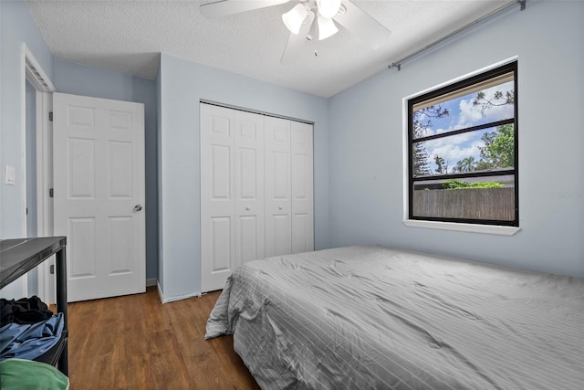 4076 Vana Dr, Sarasota, FL 34241 - bedroom with wood finished floors, a closet, a textured ceiling, and ceiling fan